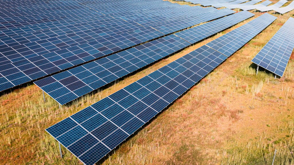 Aerial view of solar photovoltaic panels on field