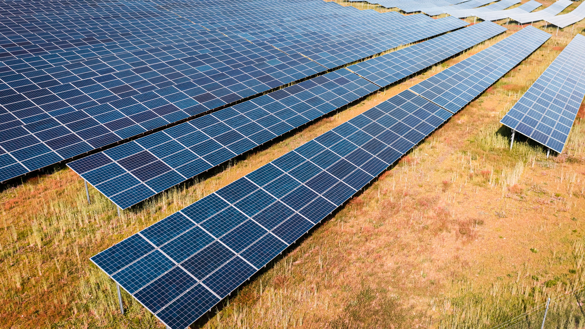 Aerial view of solar photovoltaic panels on field